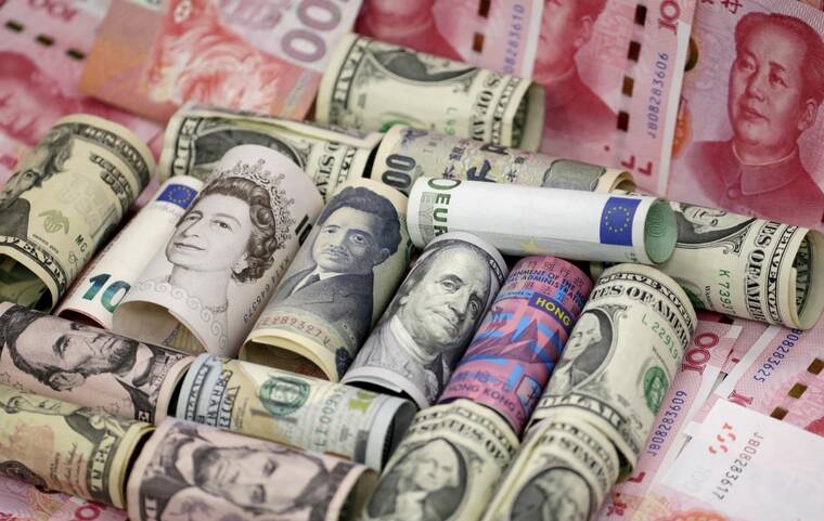 Dollar sinks after Fed signals softer outlook; Swiss franc jumps